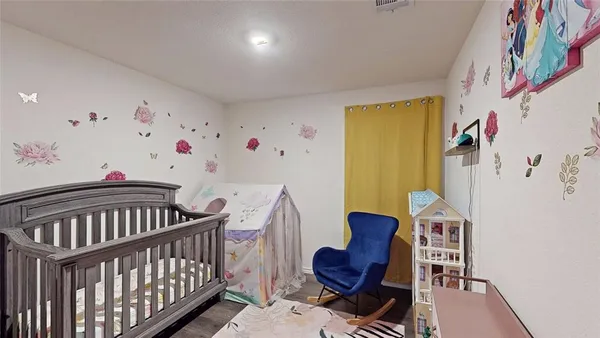 kids room with toys and wall with paintings on wall