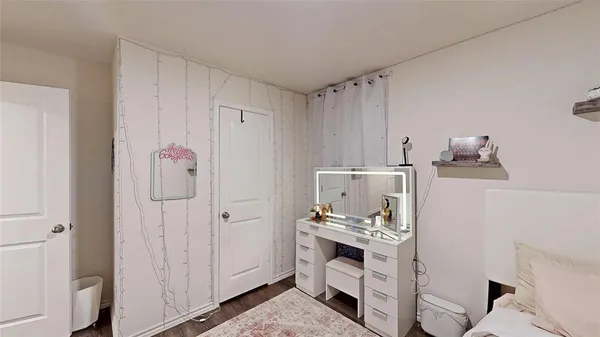 a bedroom with a bed and flat screen tv