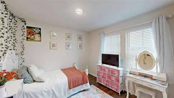 a living room with a rug and a wooden floor