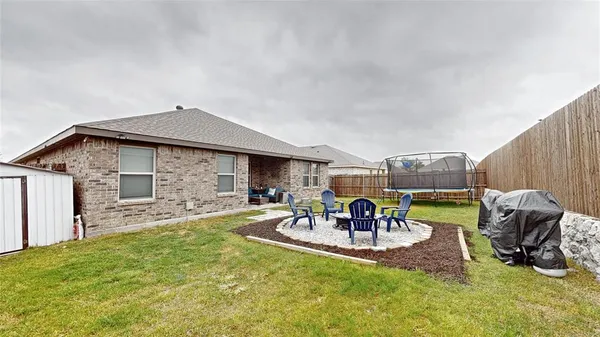 a view of a house with backyard porch and sitting area