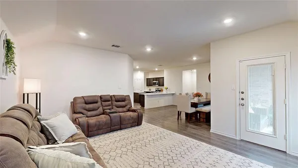 a living room with furniture rug and window