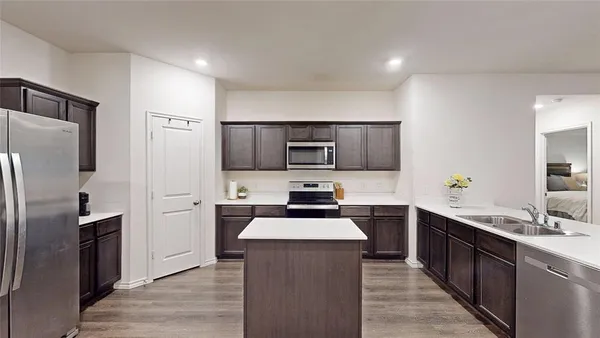 a kitchen with a sink stove and refrigerator