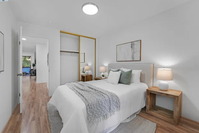 a bedroom with a bed and a large mirror