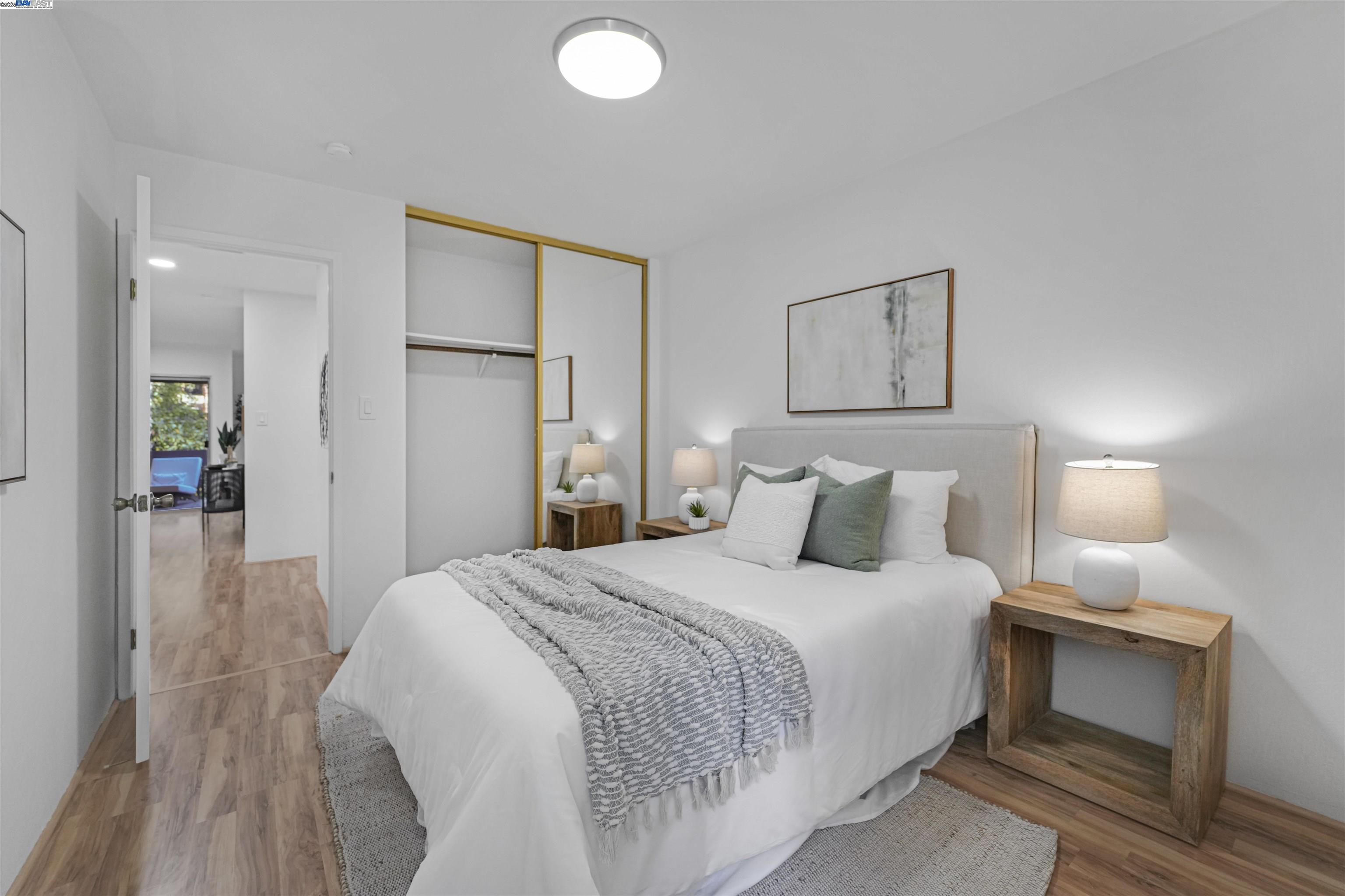 505 Cypress Point Drive, Unit 140 Mountain View, CA 94043 - Photo 18 of 60 a bedroom with a bed and a lamp