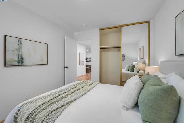 a bedroom with a bed and a painting