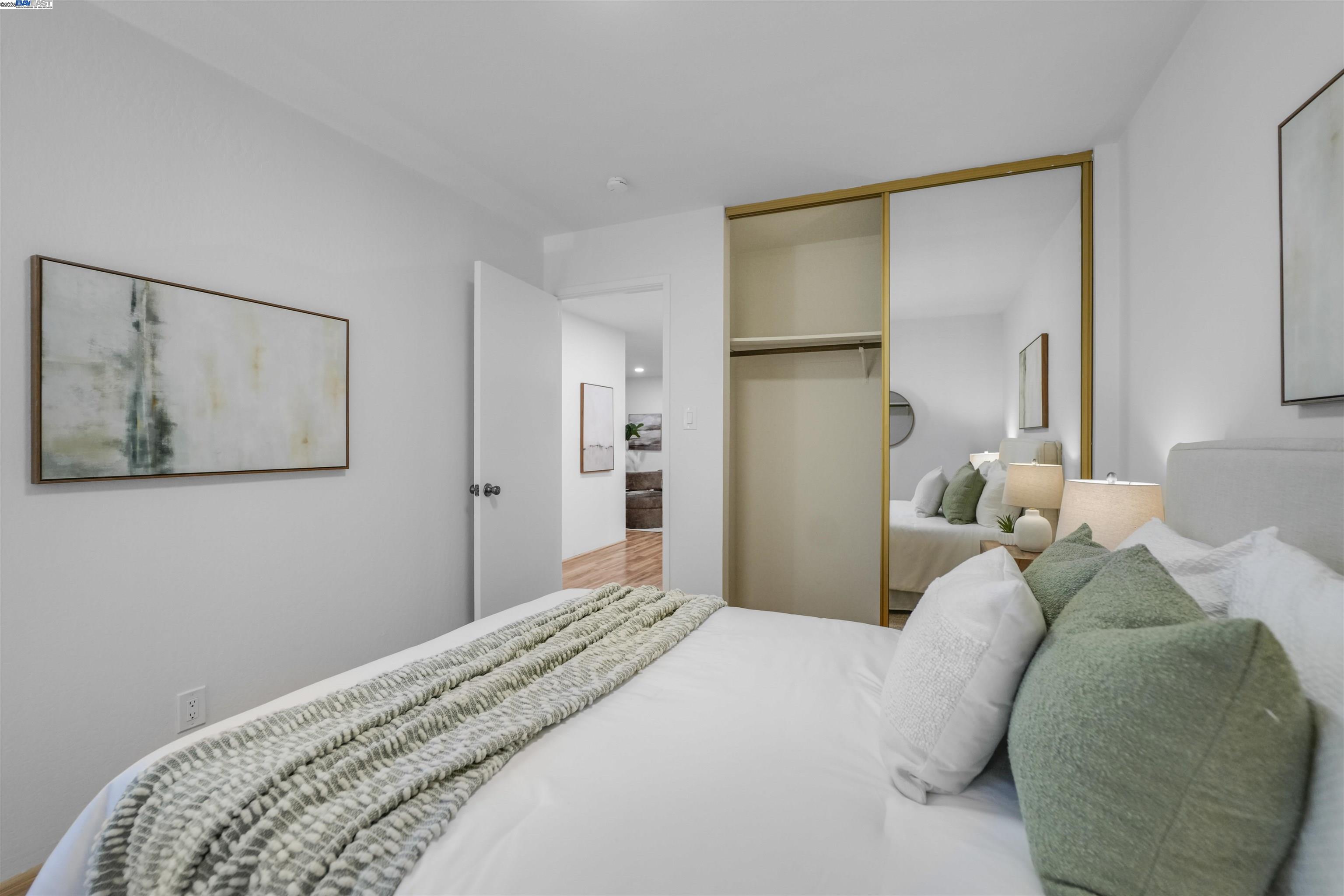 505 Cypress Point Drive, Unit 140 Mountain View, CA 94043 - Photo 19 of 60 a bedroom with a bed and a painting on the wall