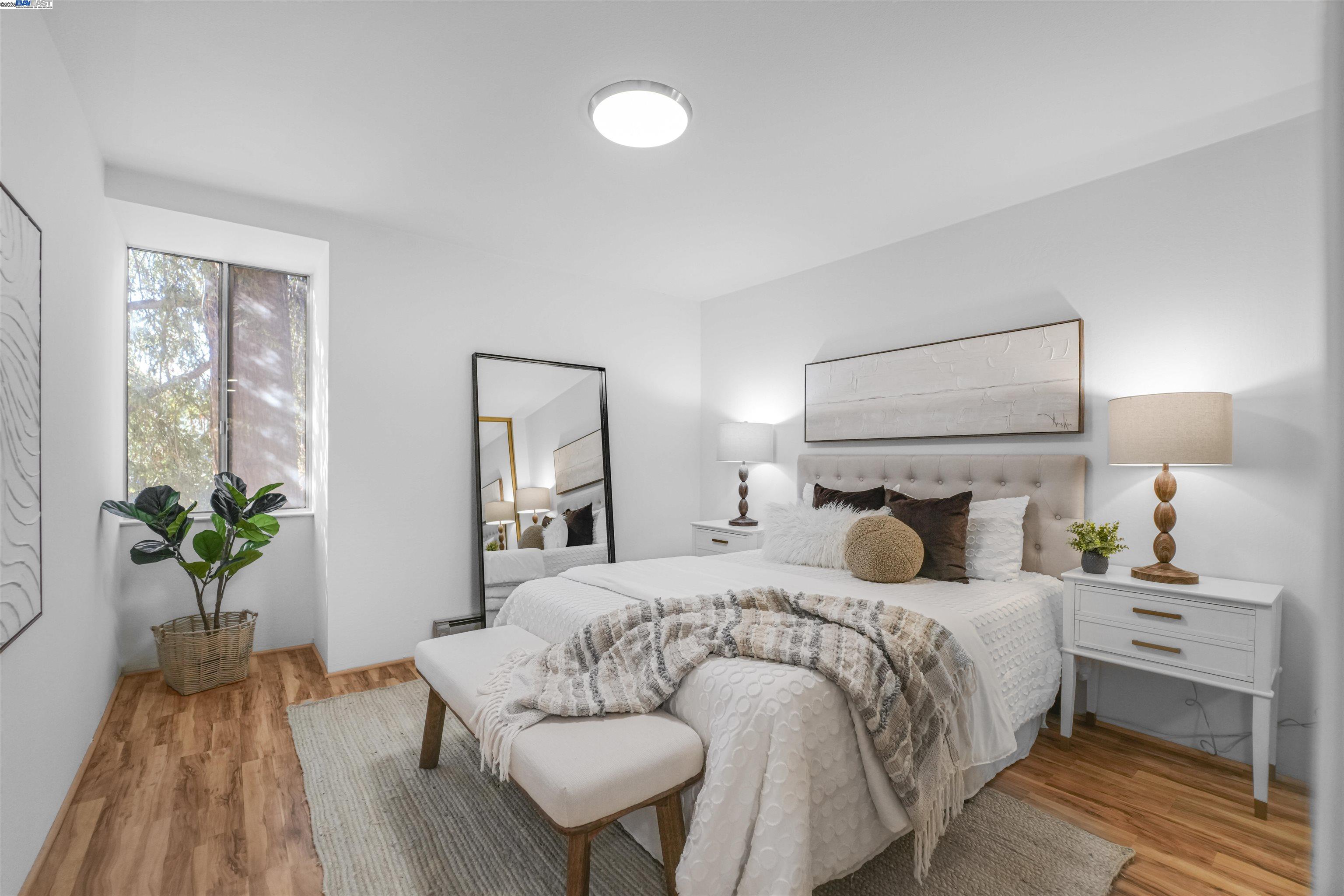 505 Cypress Point Drive, Unit 140 Mountain View, CA 94043 - Photo 21 of 60 a bedroom with a bed and a potted plant