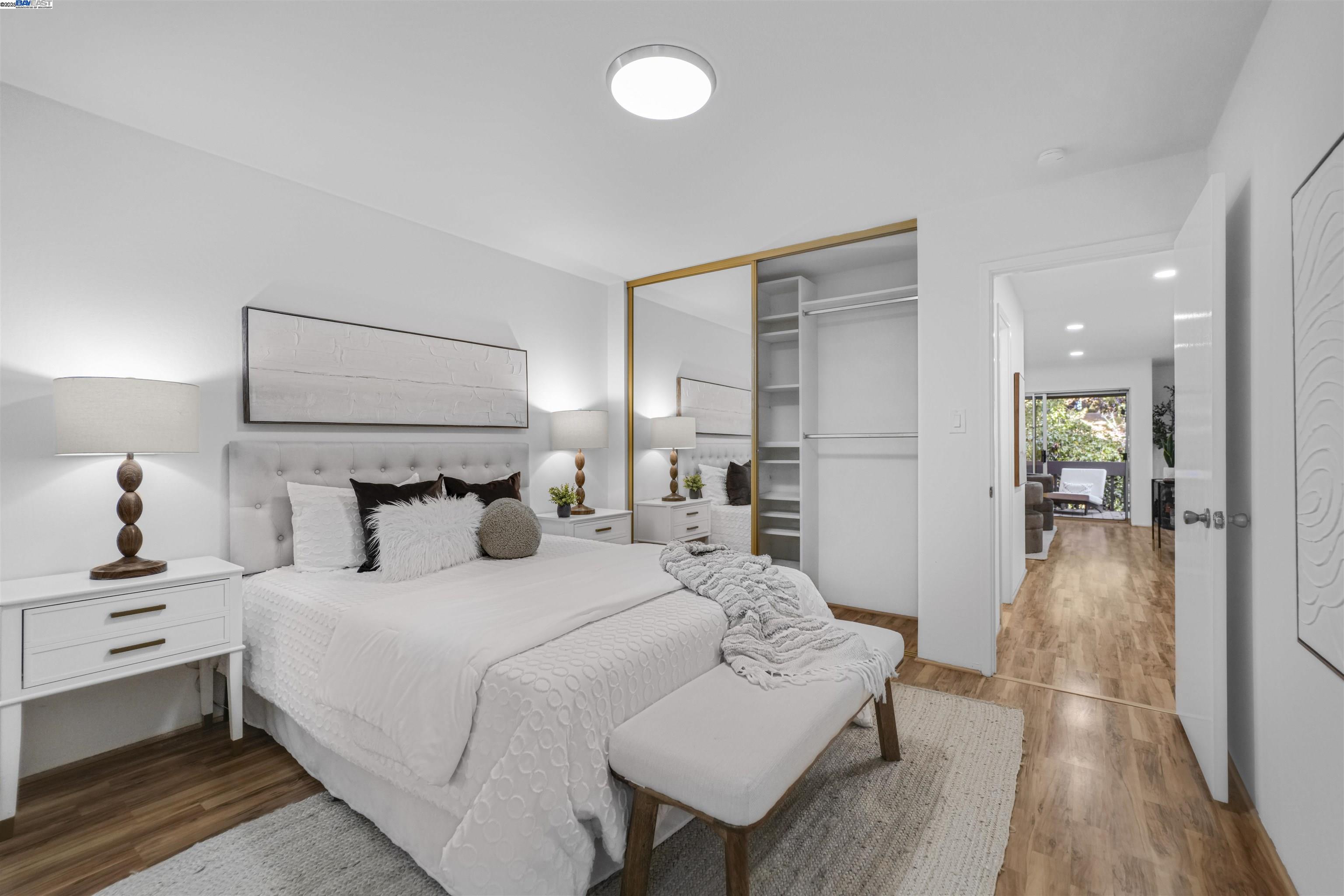 505 Cypress Point Drive, Unit 140 Mountain View, CA 94043 - Photo 22 of 60 a bedroom with a bed and a lamp