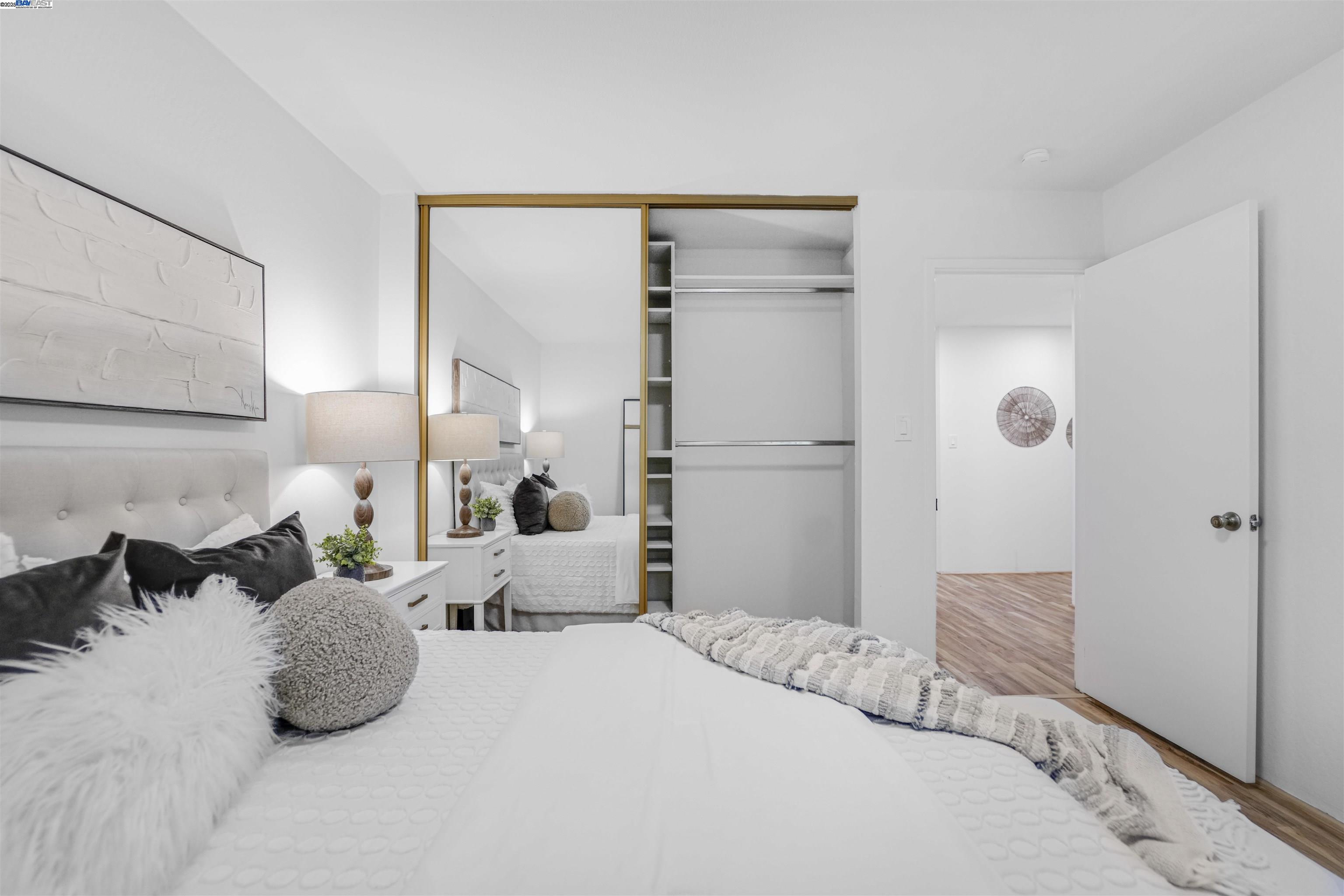 505 Cypress Point Drive, Unit 140 Mountain View, CA 94043 - Photo 23 of 60 a bedroom with a bed and a large mirror