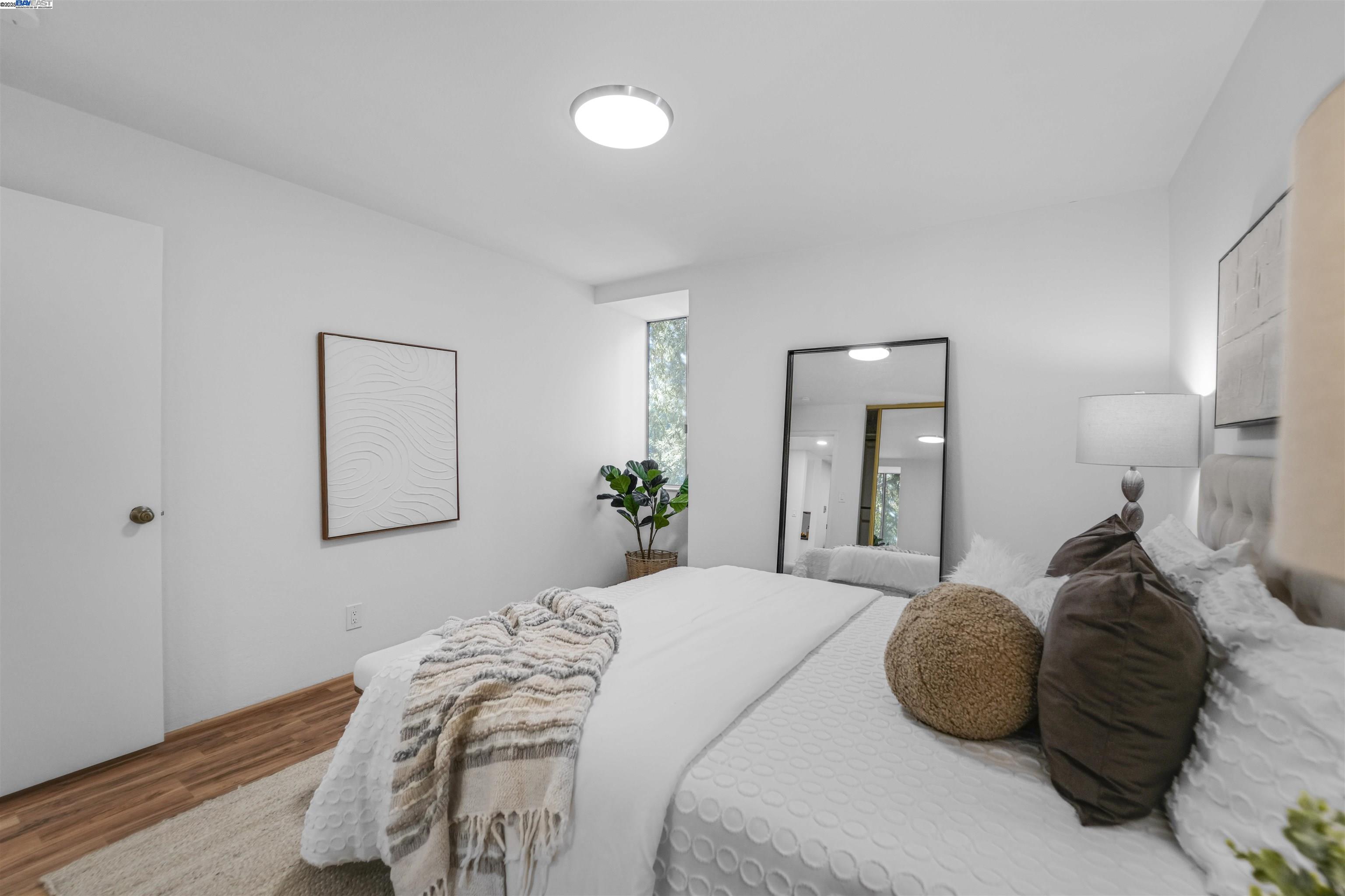 505 Cypress Point Drive, Unit 140 Mountain View, CA 94043 - Photo 24 of 60 a bedroom with a bed and a painting