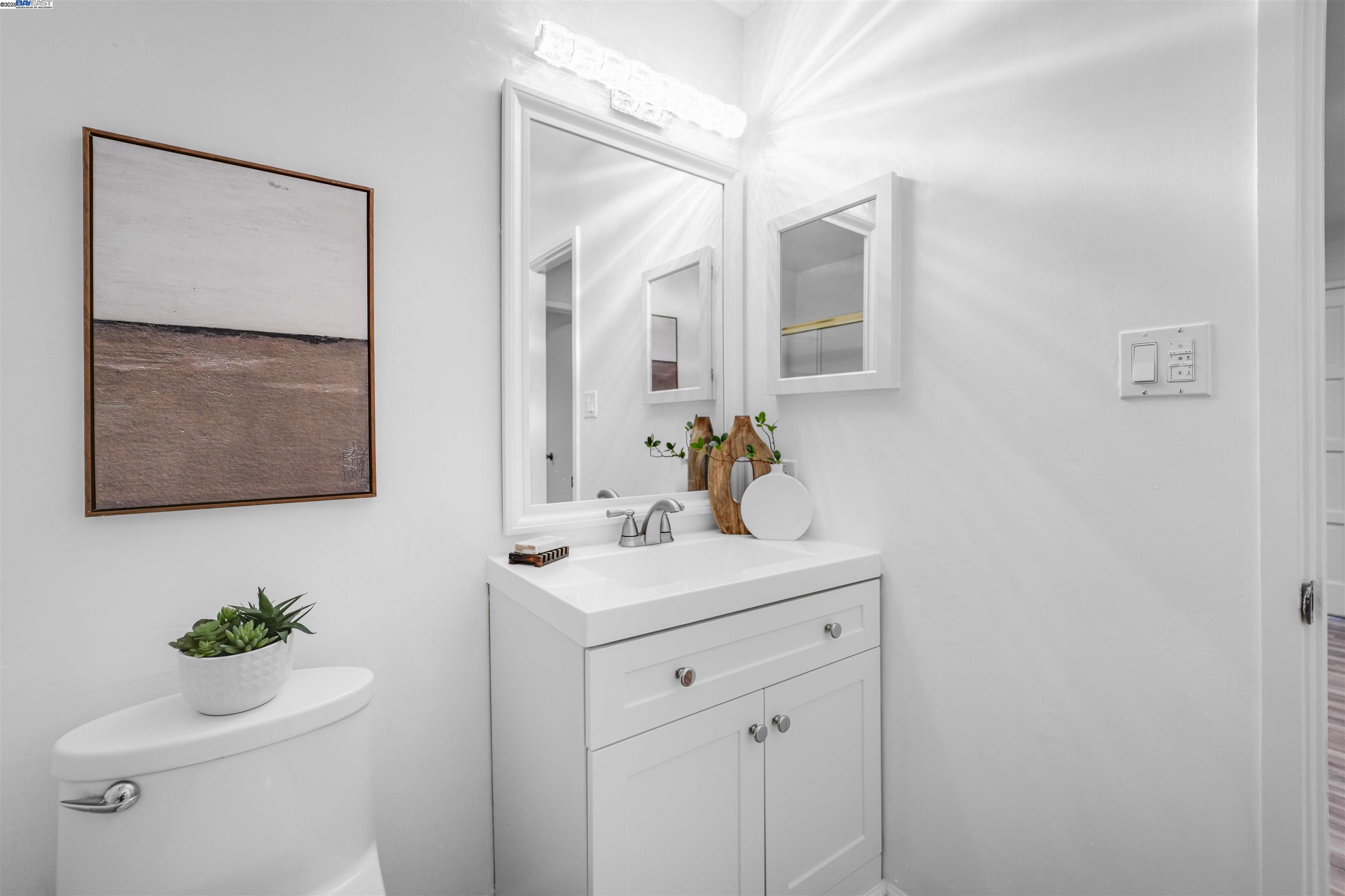 505 Cypress Point Drive, Unit 140 Mountain View, CA 94043 - Photo 25 of 60 a bathroom with a toilet sink and mirror
