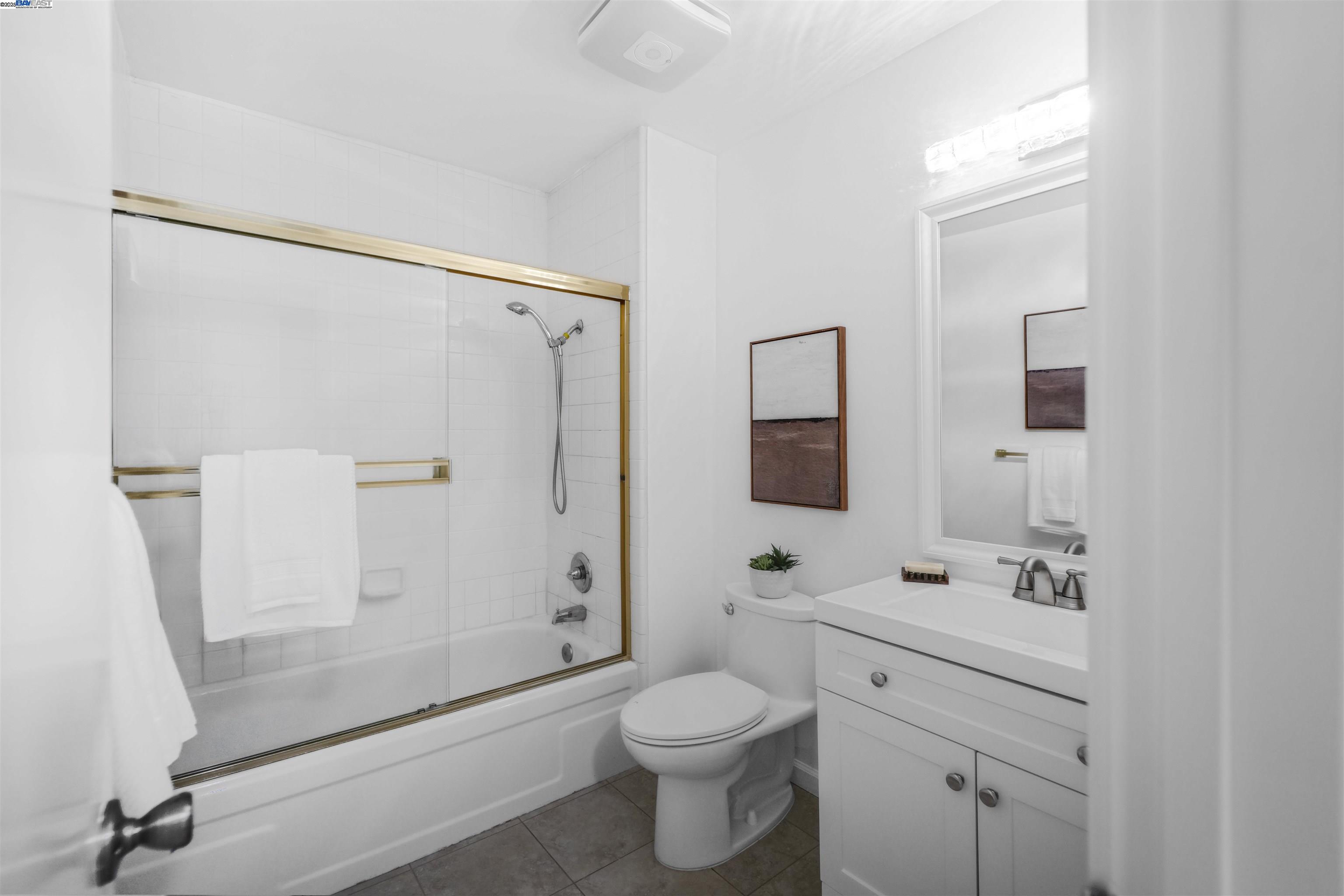 505 Cypress Point Drive, Unit 140 Mountain View, CA 94043 - Photo 28 of 60 a bathroom with a shower sink vanity mirror and toilet