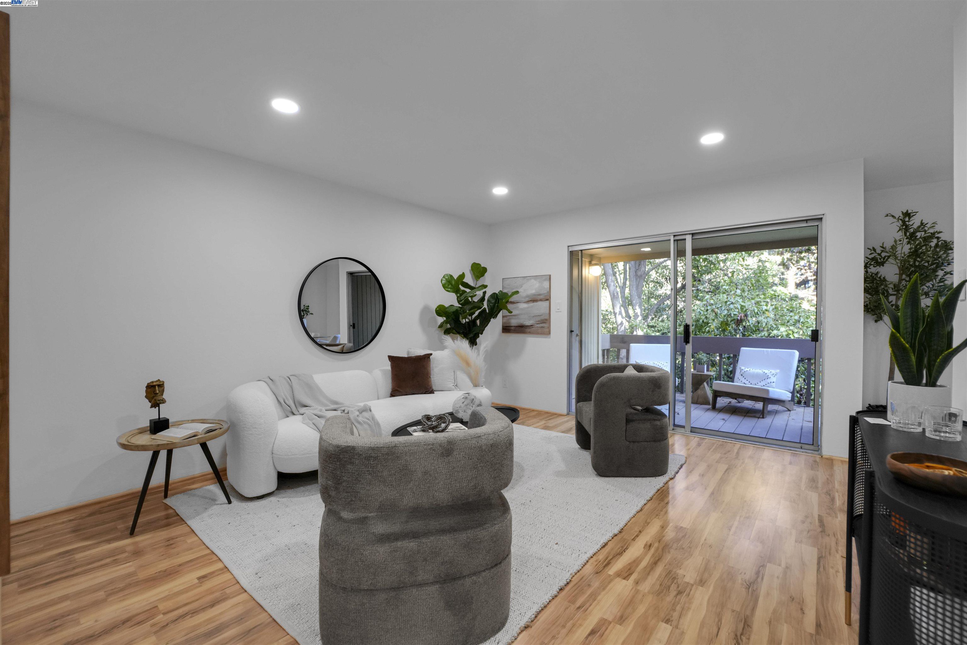 505 Cypress Point Drive, Unit 140 Mountain View, CA 94043 - Photo 29 of 60 a living room with furniture a large window and a wooden floor