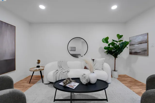 a living room with furniture and a potted plant