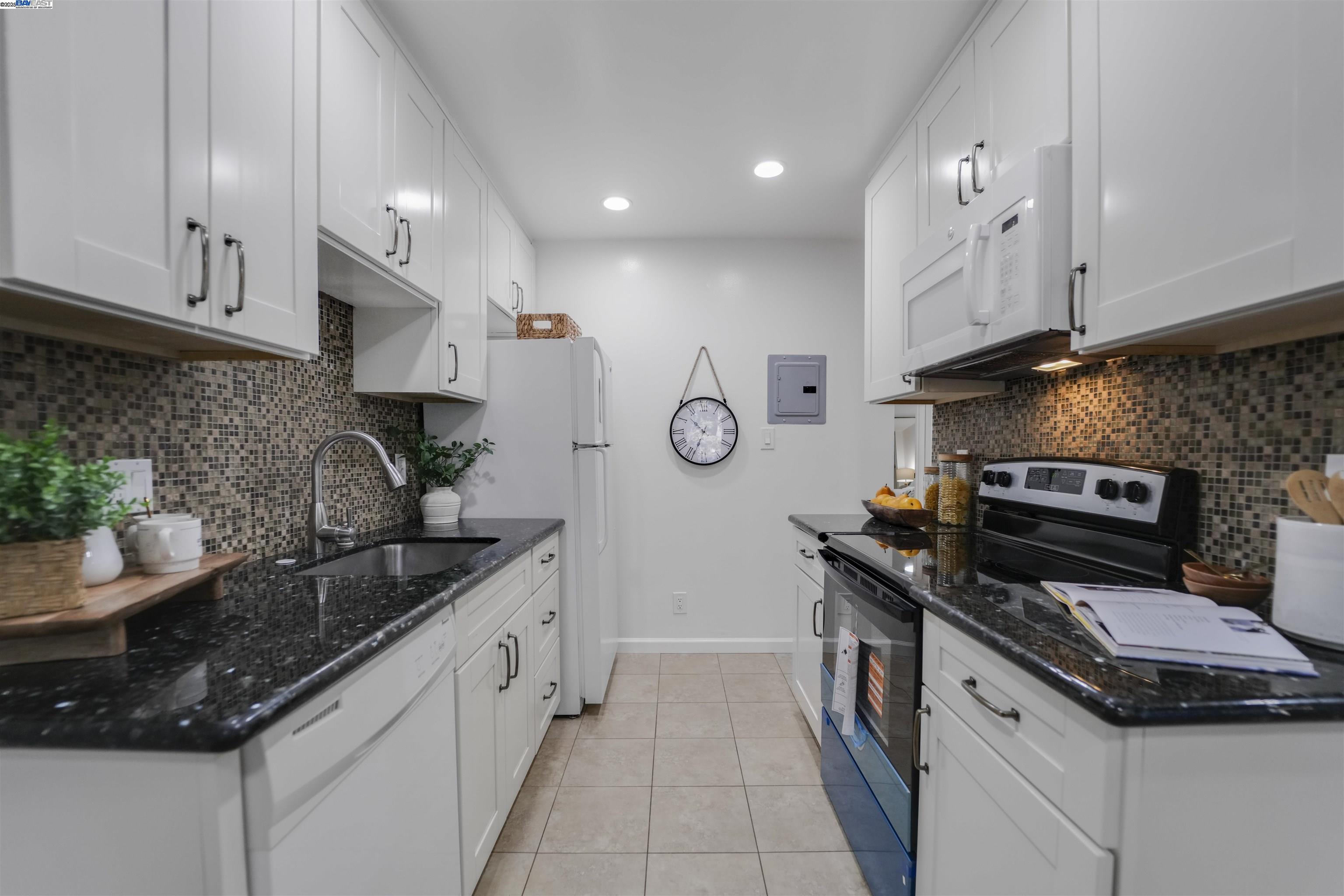 505 Cypress Point Drive, Unit 140 Mountain View, CA 94043 - Photo 39 of 60 a kitchen with stainless steel appliances granite countertop a sink stove and cabinets