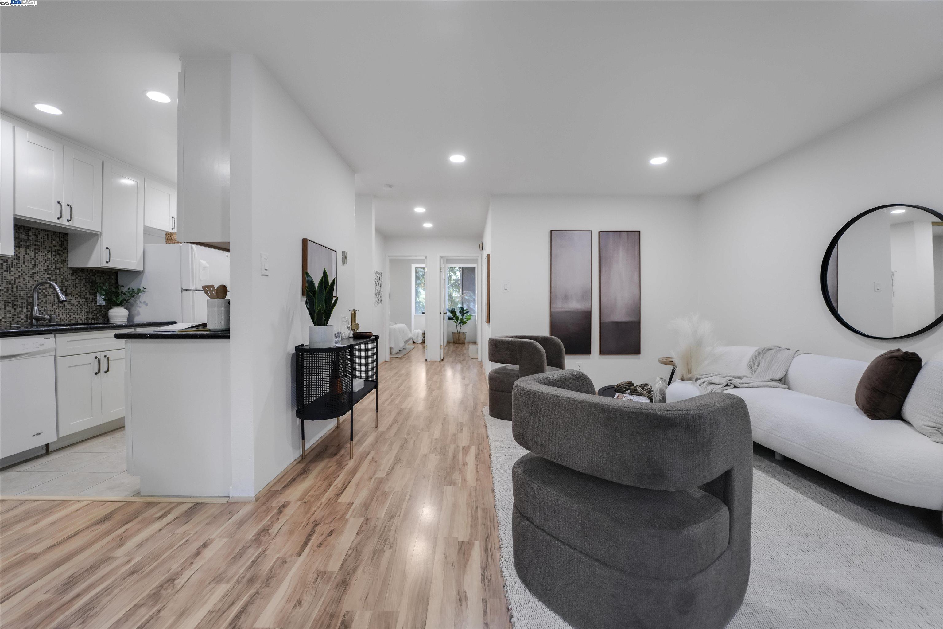 505 Cypress Point Drive, Unit 140 Mountain View, CA 94043 - Photo 46 of 60 a living room with furniture a large window and wooden floors