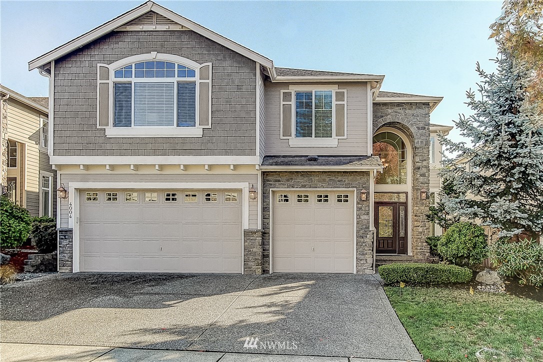 4004 215th Street Southeast Bothell, WA 98021 - Photo 1 of 25 a front view of a house with a yard and garage
