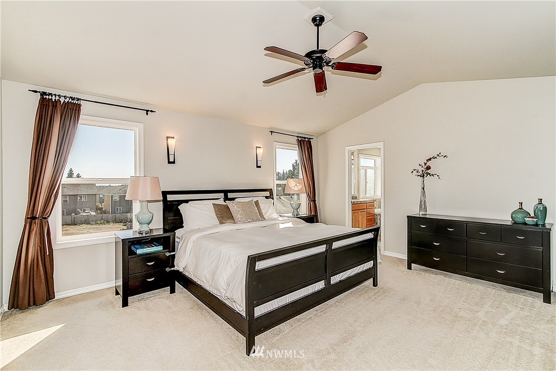 4004 215th Street Southeast Bothell, WA 98021 - Photo 13 of 25 a spacious bedroom with a bed and a dresser