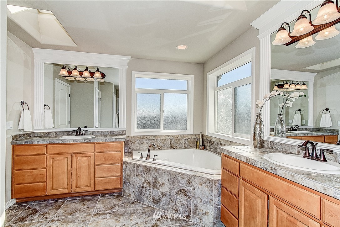 4004 215th Street Southeast Bothell, WA 98021 - Photo 15 of 25 a spacious bathroom with a granite countertop sink and a mirror