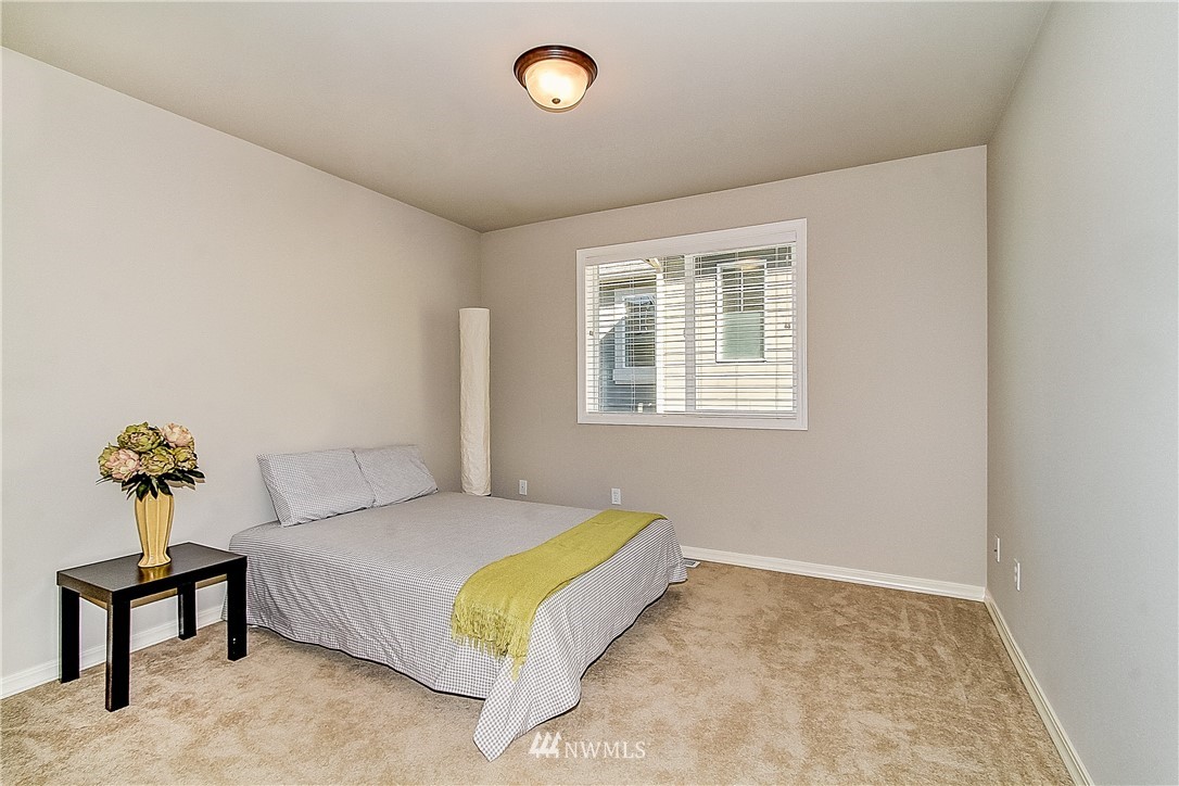 4004 215th Street Southeast Bothell, WA 98021 - Photo 20 of 25 a bedroom with a bed and painting on the wall
