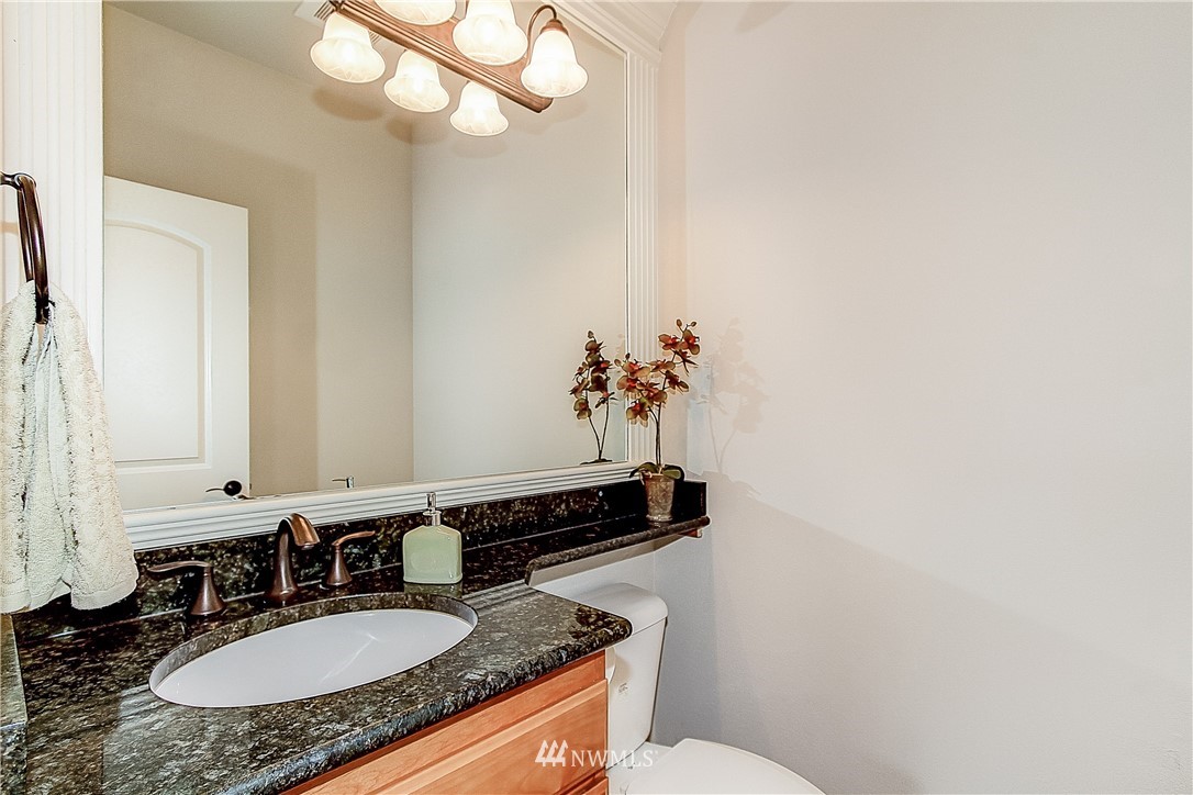 4004 215th Street Southeast Bothell, WA 98021 - Photo 23 of 25 a bathroom with a granite countertop sink and a mirror