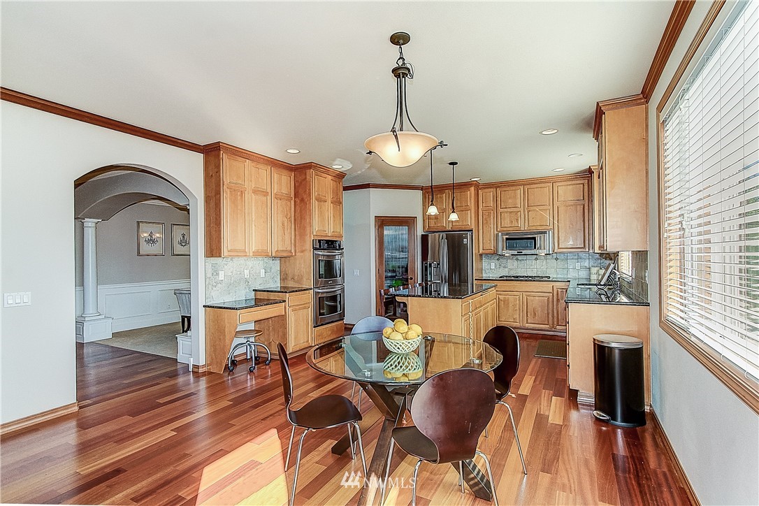 4004 215th Street Southeast Bothell, WA 98021 - Photo 10 of 25 a dining room with furniture a chandelier and wooden floor