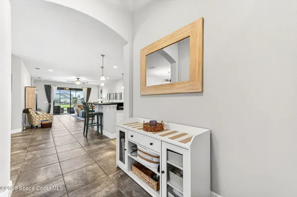 a living room with furniture a flat screen tv and a large window