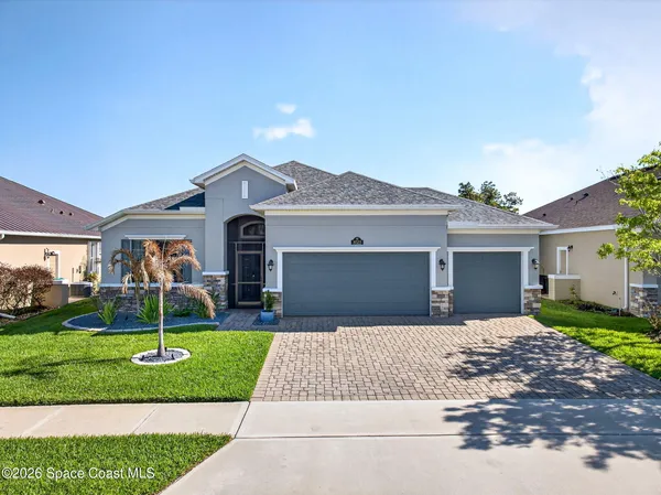 a front view of a house with a yard and garage