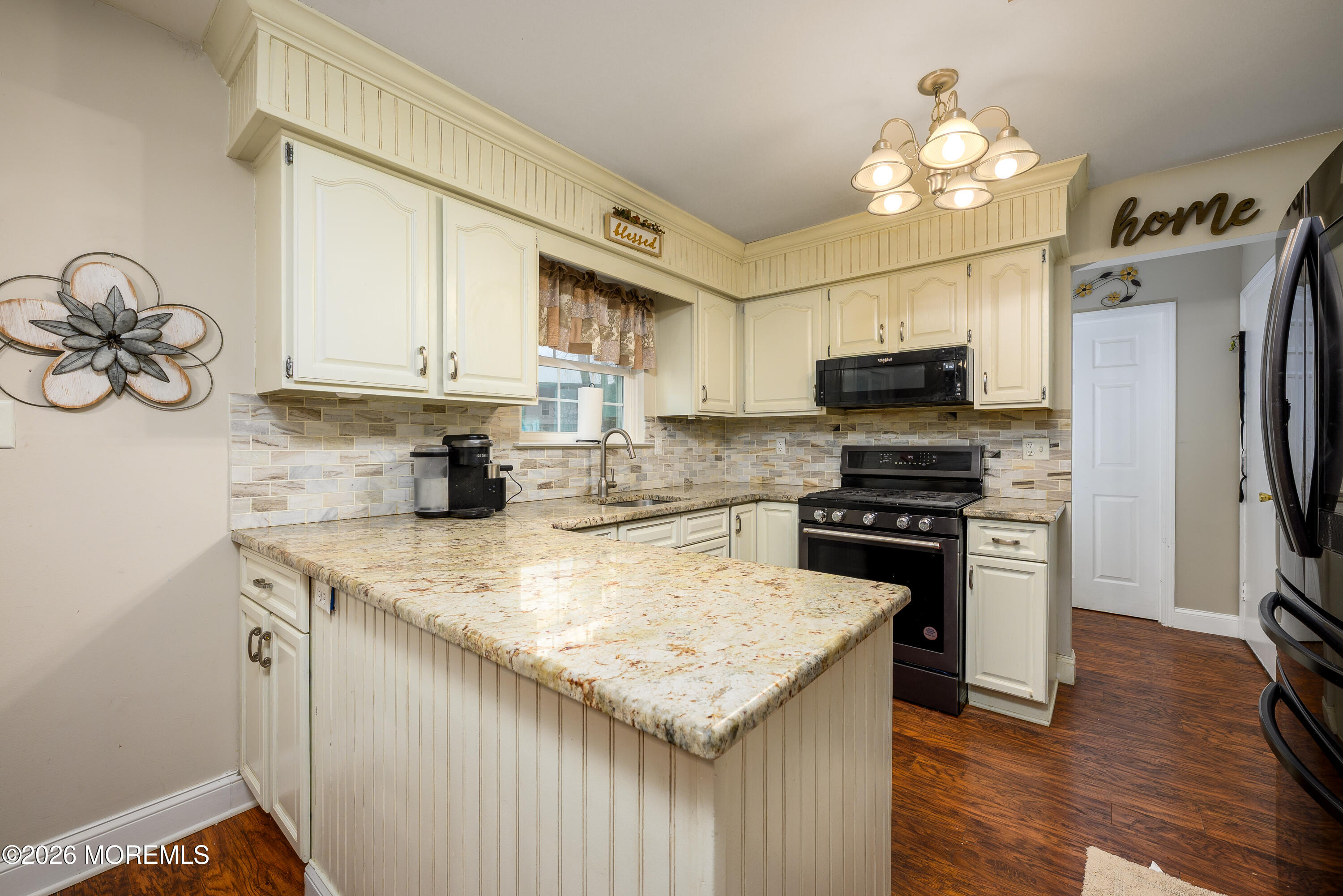 4 Cambridge Drive Howell, NJ 07731 - Photo 13 of 39 a kitchen with kitchen island granite countertop a stove cabinets and wooden floor