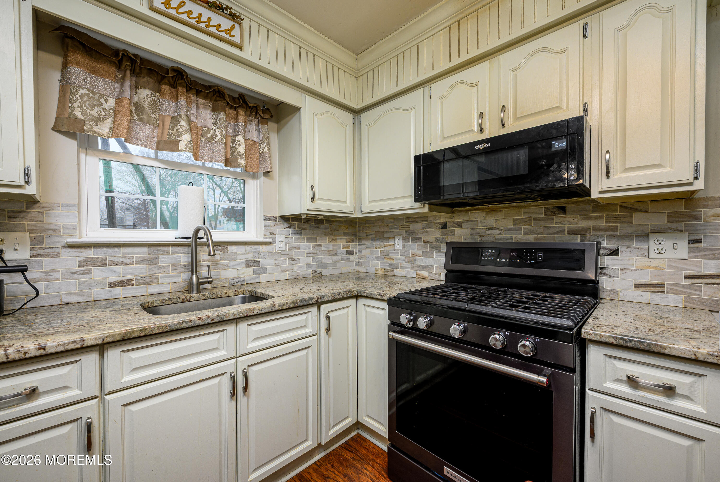 4 Cambridge Drive Howell, NJ 07731 - Photo 14 of 39 a kitchen with stainless steel appliances granite countertop white cabinets granite counter tops and a window