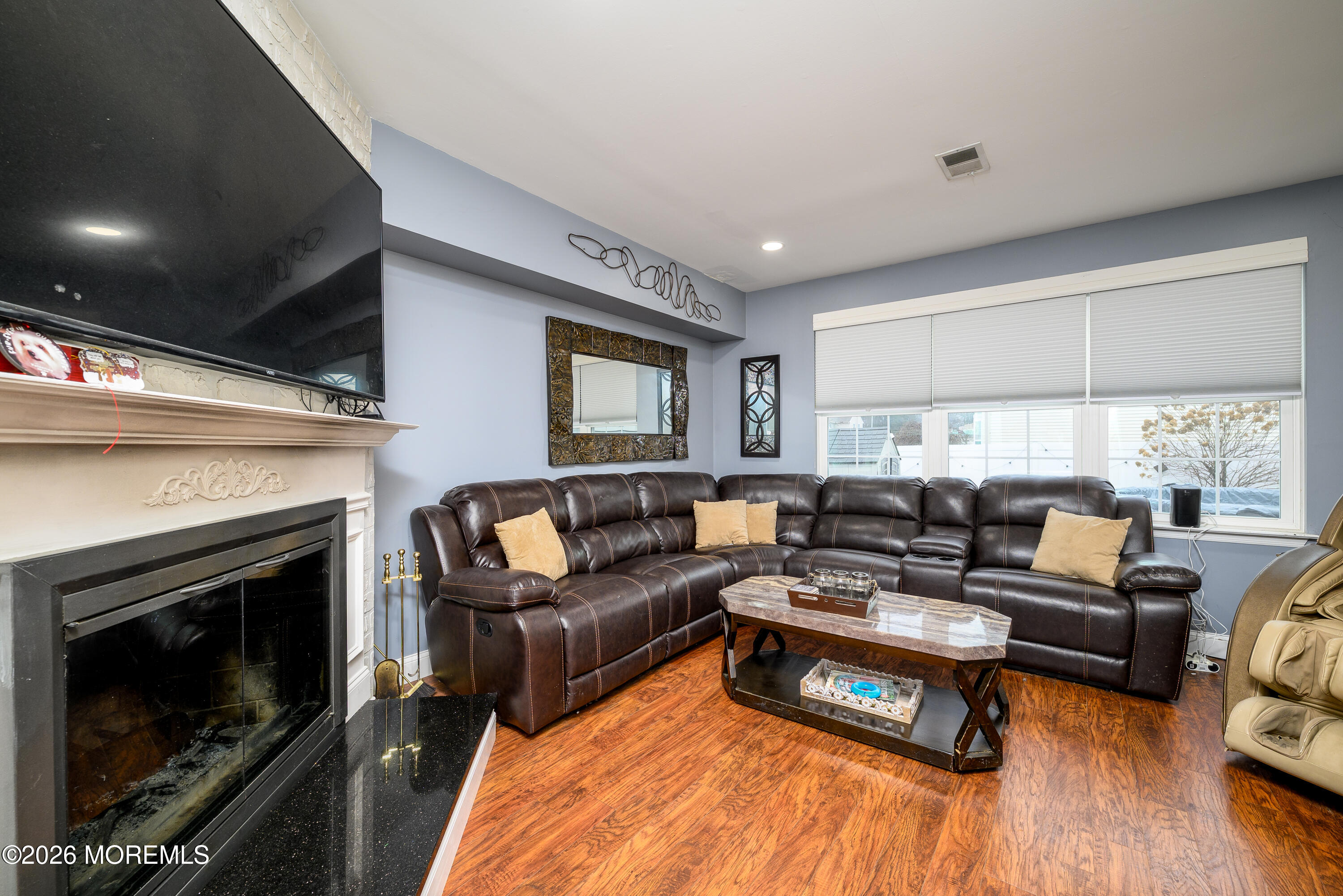 4 Cambridge Drive Howell, NJ 07731 - Photo 18 of 39 a living room with furniture a large window and a fireplace