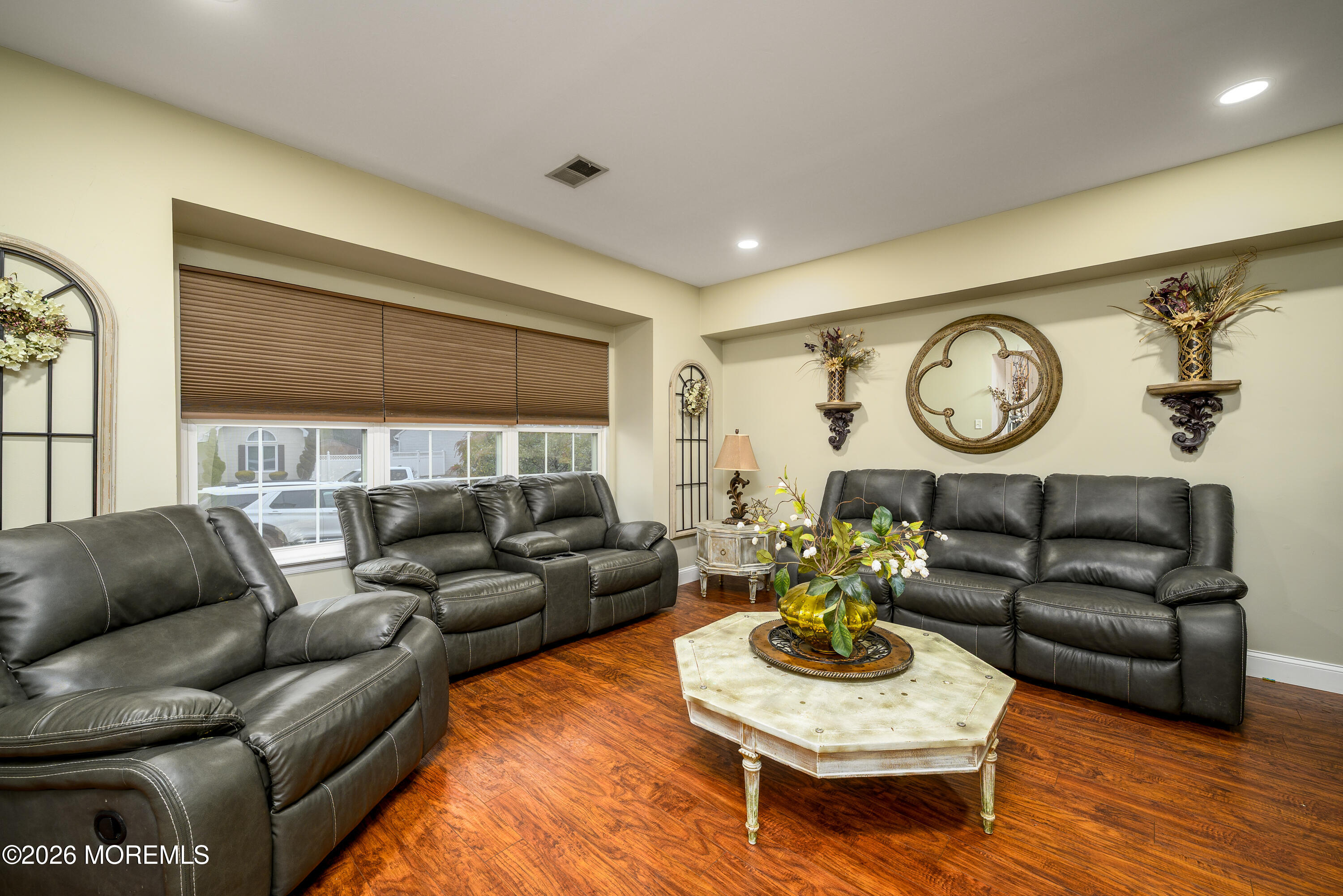 4 Cambridge Drive Howell, NJ 07731 - Photo 9 of 39 a living room with furniture a clock on wall and a window