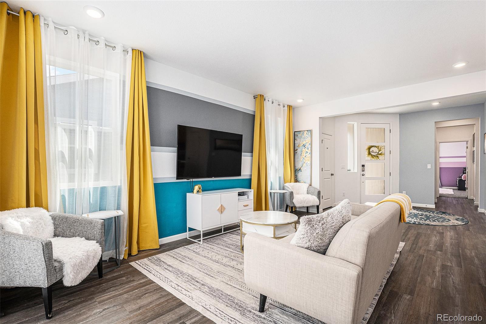 3522 North Buchanan Way Aurora, CO 80019 - Photo 11 of 30 a living room with furniture and a flat screen tv