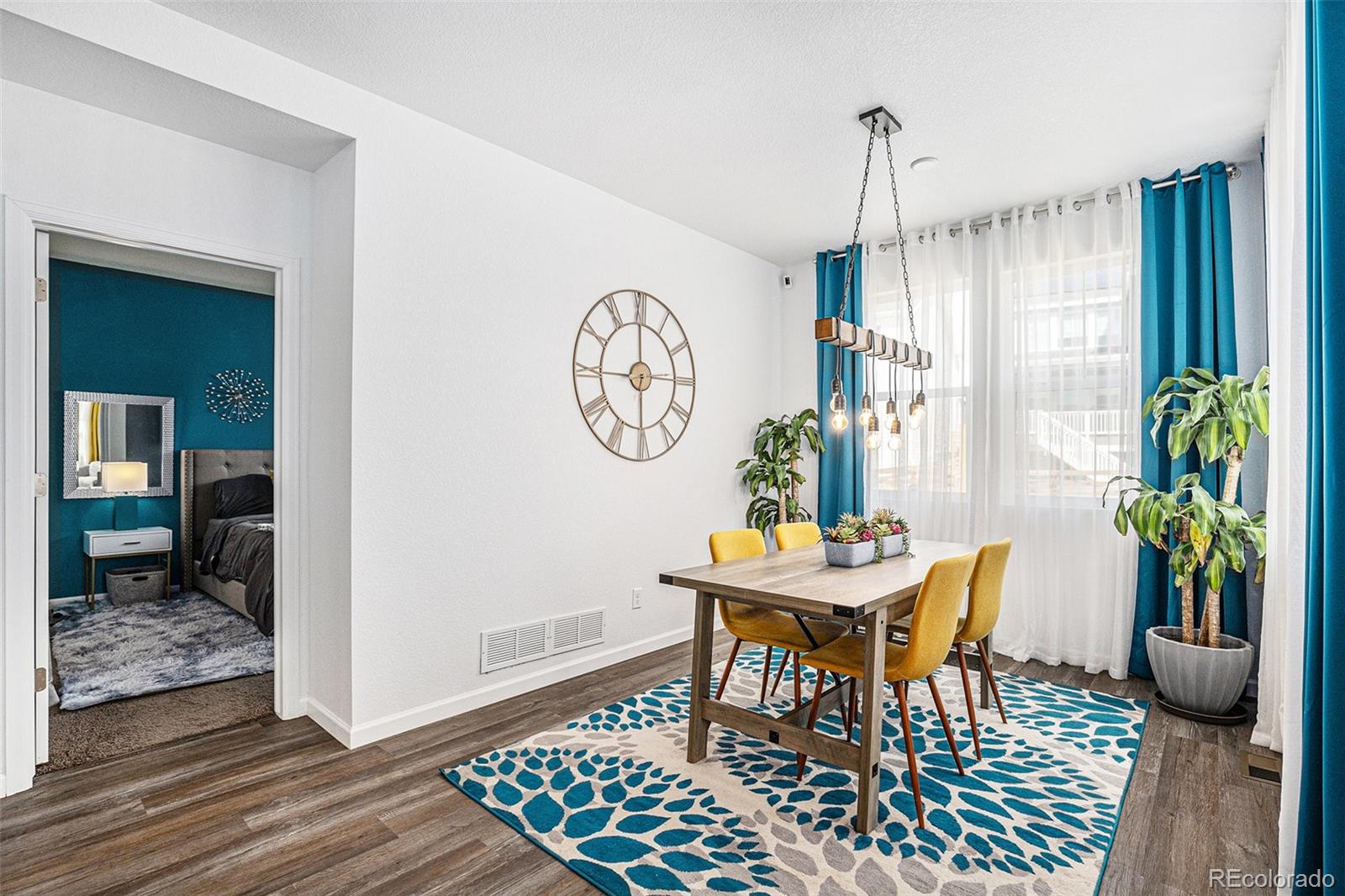 3522 North Buchanan Way Aurora, CO 80019 - Photo 14 of 30 a view of a dining room with furniture window and wooden floor