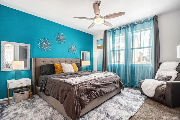 a bedroom with a bed and a couch