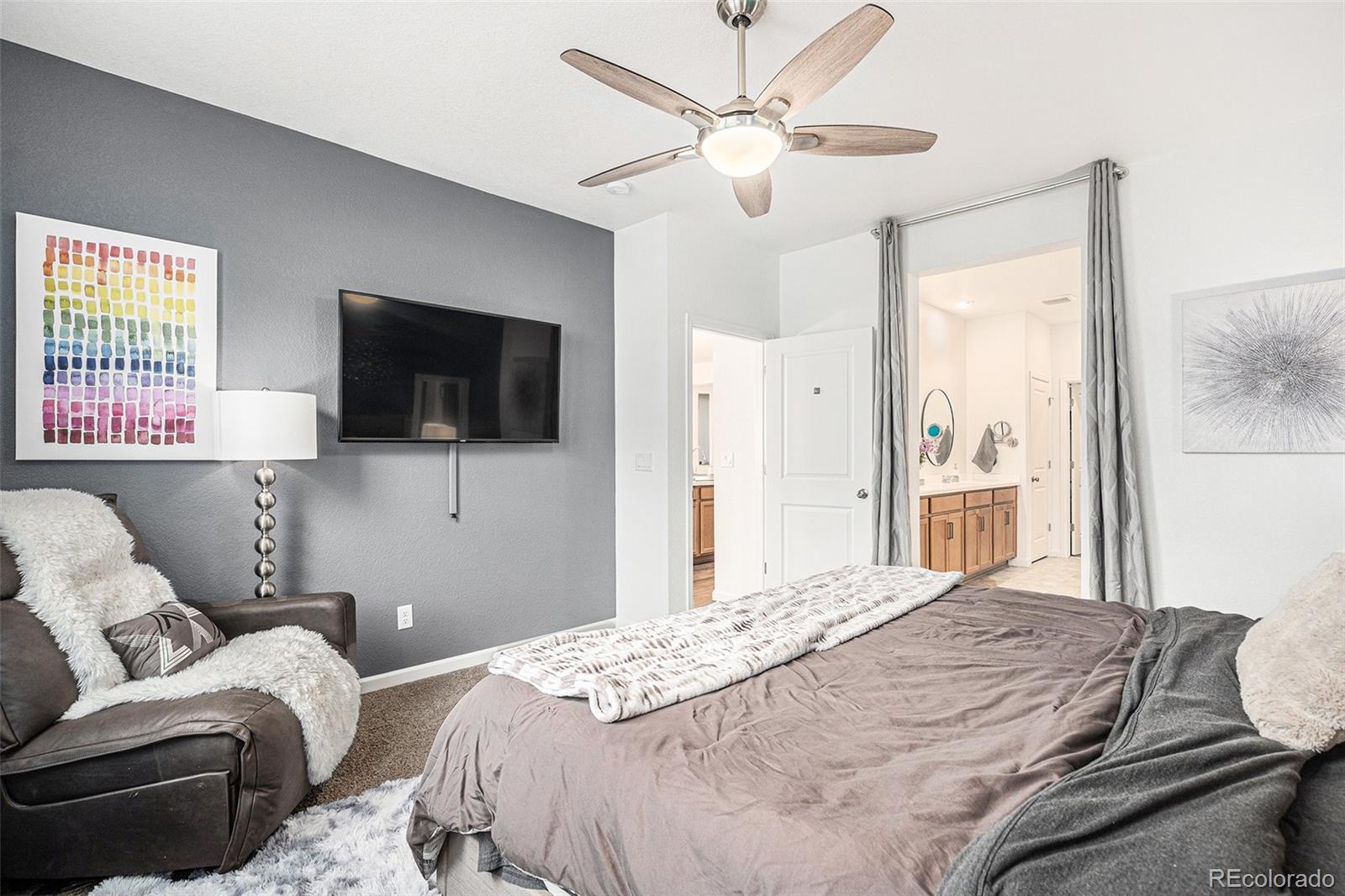 3522 North Buchanan Way Aurora, CO 80019 - Photo 16 of 30 a bedroom with a bed and a flat screen tv
