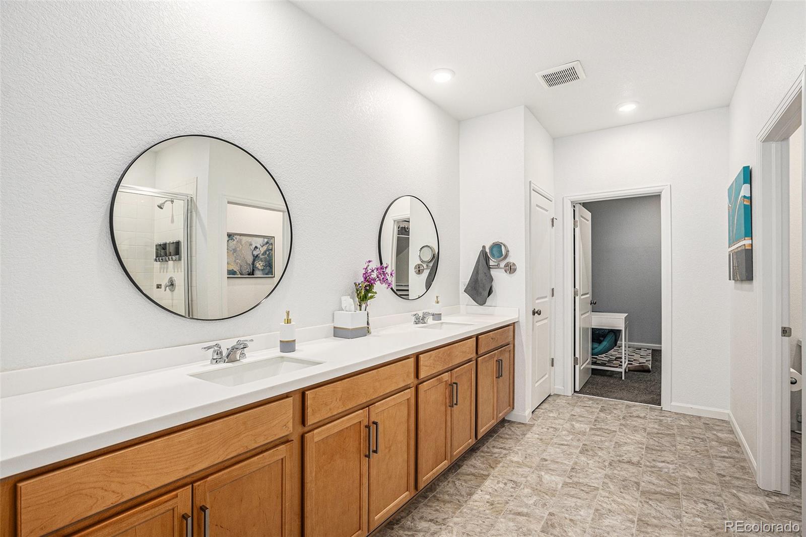 3522 North Buchanan Way Aurora, CO 80019 - Photo 17 of 30 a spacious bathroom with a double vanity sink and a mirror