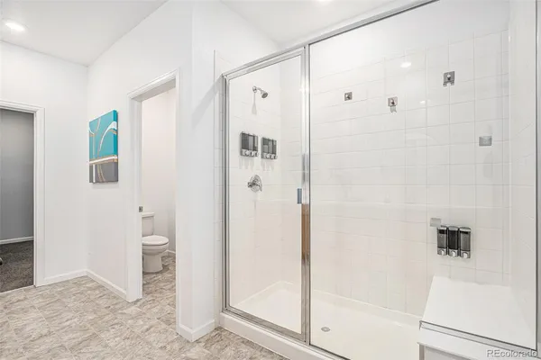 a bathroom with a shower and a glass door