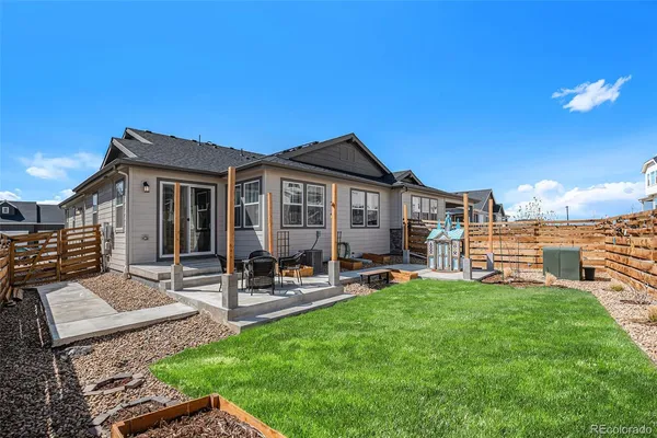 a view of a house with backyard porch and sitting area