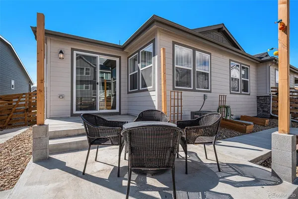 a view of a house with backyard and sitting area