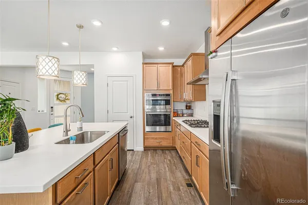 a kitchen with stainless steel appliances granite countertop a sink and stove