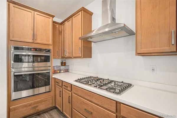 a kitchen with stainless steel appliances granite countertop a stove and a microwave