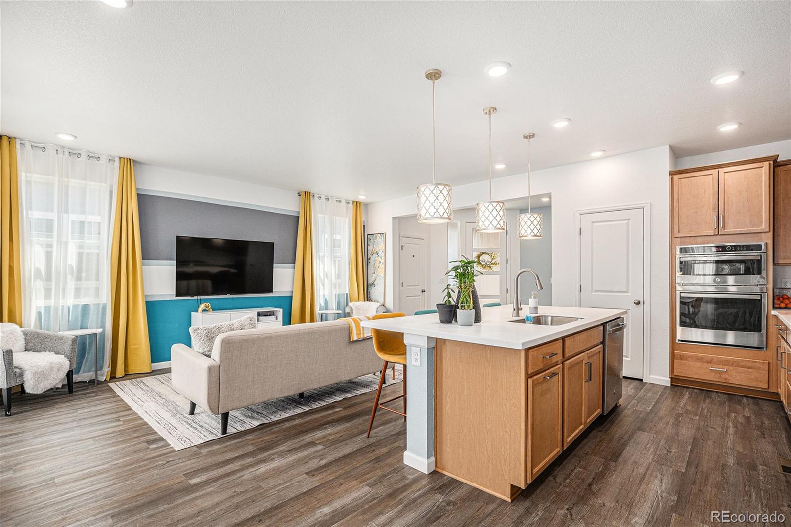 3522 North Buchanan Way Aurora, CO 80019 - Photo 8 of 30 a view of kitchen with stainless steel appliances granite countertop a stove and a wooden floors