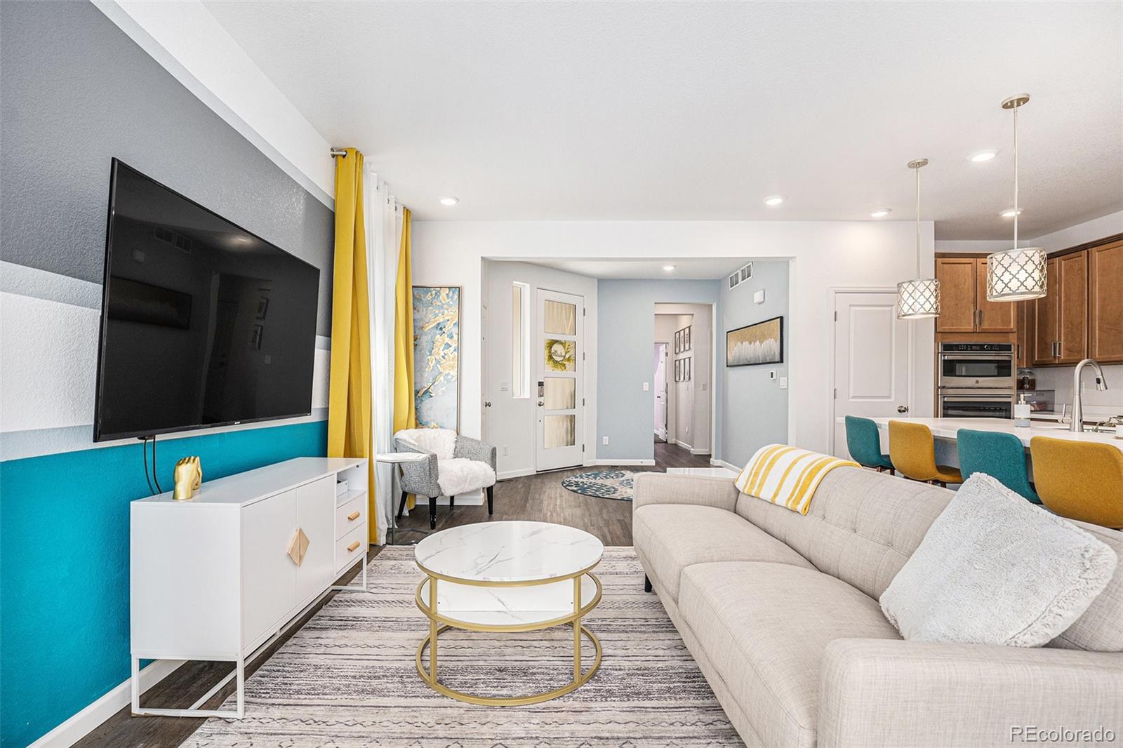 3522 North Buchanan Way Aurora, CO 80019 - Photo 10 of 30 a living room with furniture and a flat screen tv