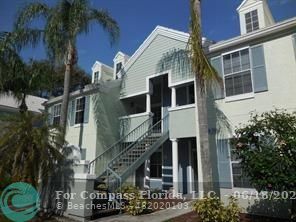 1020 Crystal Way, Unit D Delray Beach, FL 33444 - Photo 1 of 24 a front view of a house with a garden
