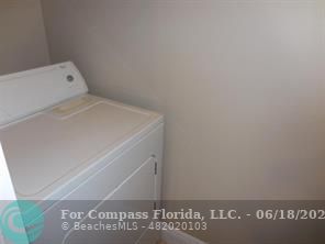1020 Crystal Way, Unit D Delray Beach, FL 33444 - Photo 14 of 24 a utility room with dryer and washer