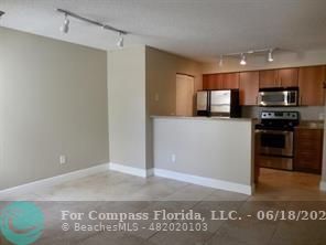 1020 Crystal Way, Unit D Delray Beach, FL 33444 - Photo 20 of 24 a kitchen with stainless steel appliances granite countertop a refrigerator and a stove