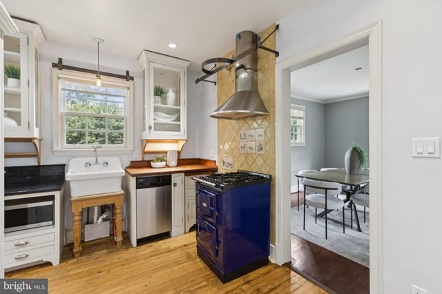 a view of a kitchen with granite countertop a stove and a wooden floors