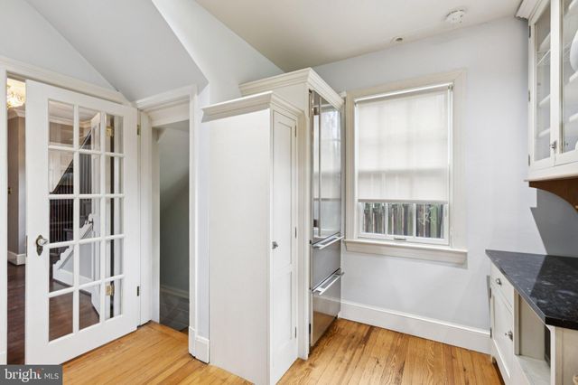 a view of wooden floor and windows in a room
