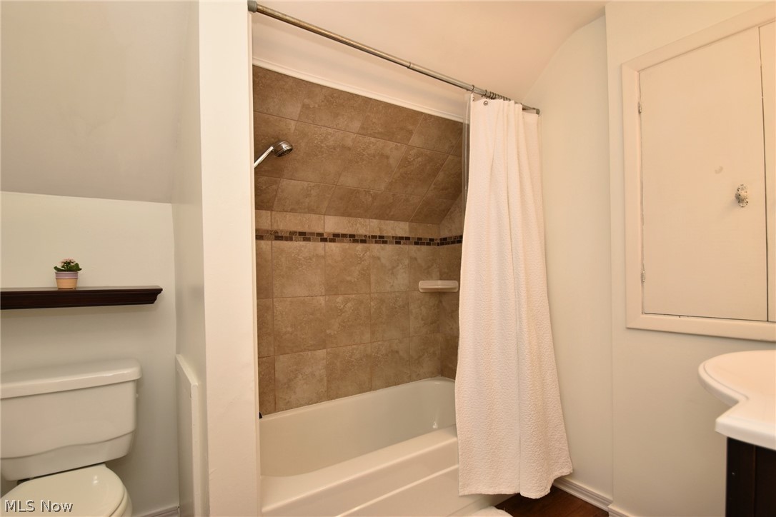 1174 Haverston Road Cleveland, OH 44124 - Photo 18 of 21 Full bathroom featuring shower / bath combo with shower curtain, toilet, and vanity